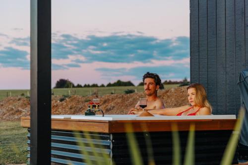 a man and a woman in a bath tub at Rest at BoxGrove in Bathurst