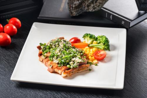 a white plate of food with vegetables and meat at Holiday Inn & Suites Chongqing Nanan by IHG in Chongqing