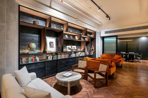 a living room with couches and chairs and a table at Else Kuala Lumpur, a member of Design Hotels in Kuala Lumpur