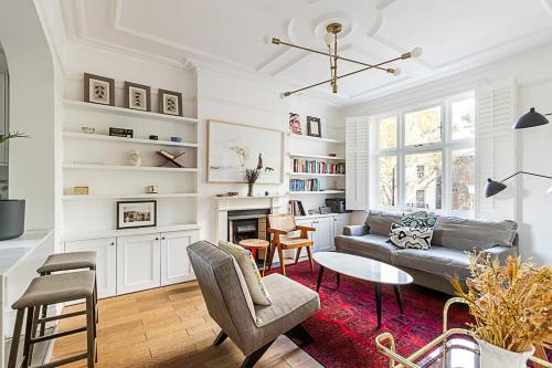 a living room with a couch and a fireplace at Stunning Maida Vale Apartment in London
