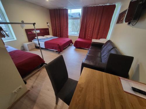 a living room with a couch and a bed and a table at Viva Nord Hotel in Tallinn