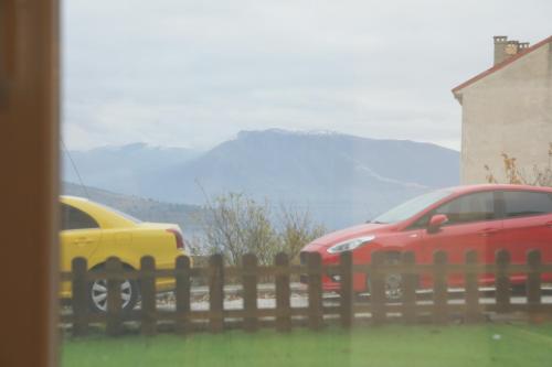 two cars parked next to a wooden fence at Vista sull'acqua in Kastoria