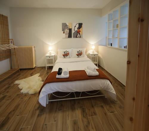 a bedroom with a large bed and two night stands at Vista sull'acqua in Kastoria