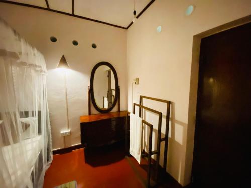 a room with a mirror and a hallway at Golden Reef Villa Hikkaduwa in Hikkaduwa