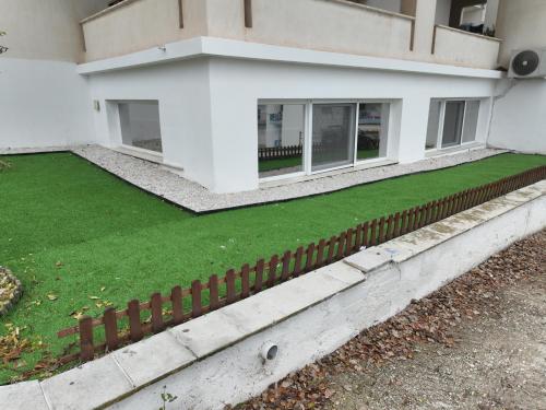 a house with a green lawn in front of it at Vista sull'acqua in Kastoria