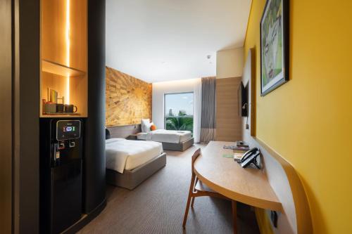 a hotel room with a bedroom with a bed and a desk at SUN & MOON, Riverside Hotel in Phnom Penh