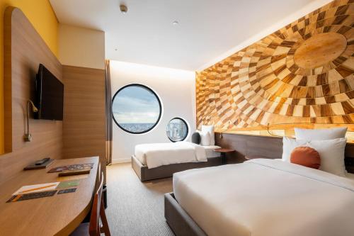 a hotel room with two beds and a desk at SUN & MOON, Riverside Hotel in Phnom Penh