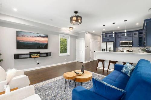 a living room with a blue couch and a kitchen at LuxHome Chicago 8 mins Downtown in Chicago