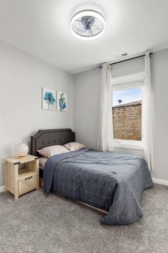 a bedroom with a bed and a window at LuxHome Chicago 8 mins Downtown in Chicago