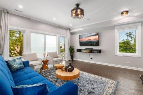 a living room with a blue couch and a table at LuxHome Chicago 8 mins Downtown in Chicago