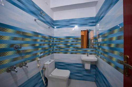 a bathroom with a toilet and a sink at Venice Rosedale in Alleppey