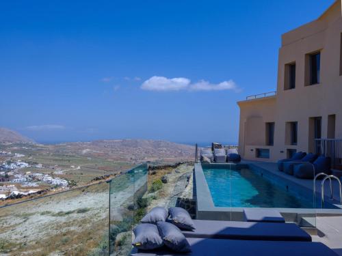 a villa with a swimming pool with a view at Kalestesia Suites in Akrotiri