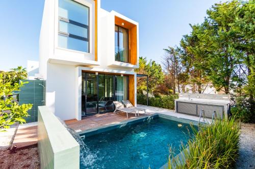 a house with a swimming pool and a deck at Villa Laurus 4 by Ezoria Villas in Paphos