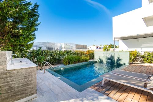 a swimming pool in the backyard of a house at Villa Laurus 4 by Ezoria Villas in Paphos