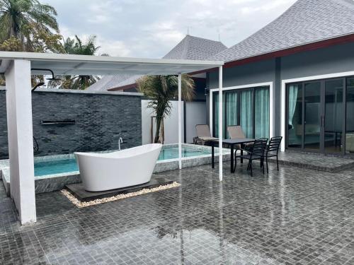 a bath tub sitting on the patio of a house at The M Millions Pool Villa, Aonang Krabi -Free Shuttle to Aonang Beach in Ao Nang Beach