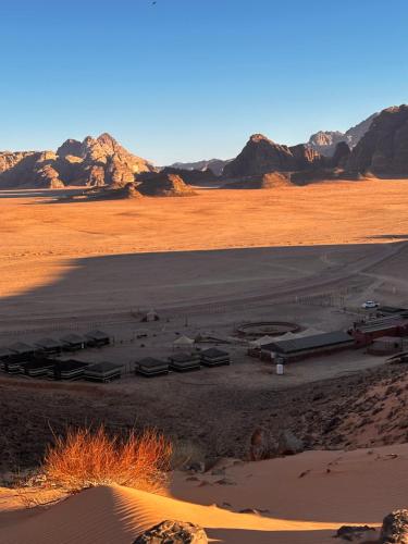 a view of a desert with mountains in the background at Dream Bedouin Life Camp Wadi Rum in Disah