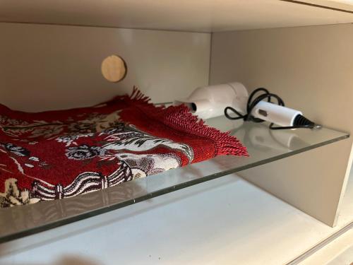 a glass shelf with a red blanket on top of it at 4 Bedroom House with Swimmin Pool at PD by MAISON in Port Dickson