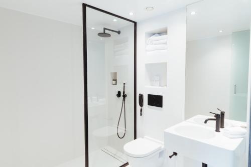 a bathroom with a shower and a toilet and a sink at Periscope in Athens
