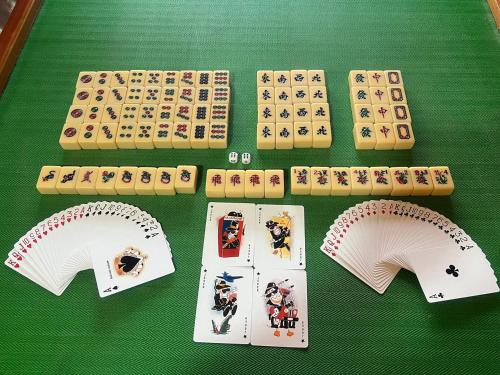 a green table with playing cards and poker chips at 4 Bedroom House with Swimmin Pool at PD by MAISON in Port Dickson