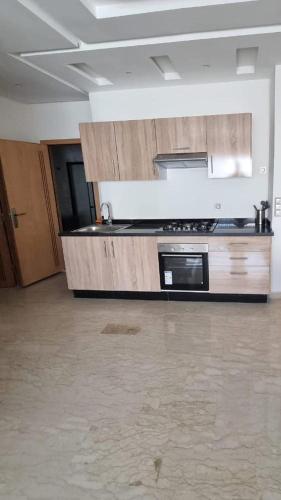 a kitchen with a stove and a counter top at Cosy Apparts 2BR, in downtown, near Anoual Tramway in Casablanca