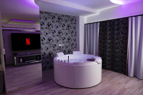 a living room with a white round table and a tv at Suite17 - Luxury GuestHouse in Giovinazzo