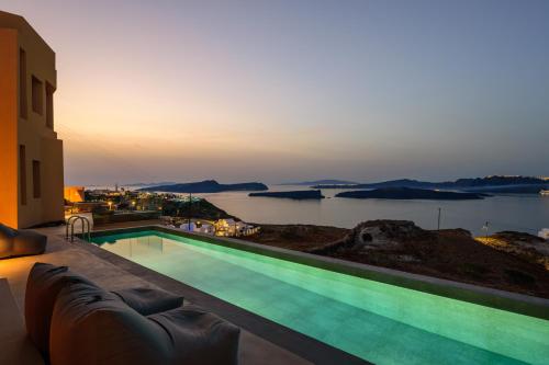 a swimming pool with a view of the water at Kalestesia Suites in Akrotiri