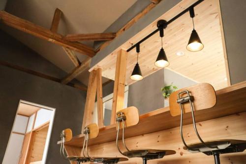 a kitchen with a counter with lights and a mirror at Tob-inn Myoko in Myoko