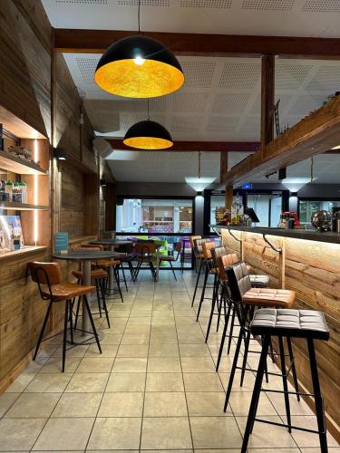 a restaurant with tables and chairs in a room at CIS-Ethic Etapes de Val Cenis in Lanslebourg-Mont-Cenis