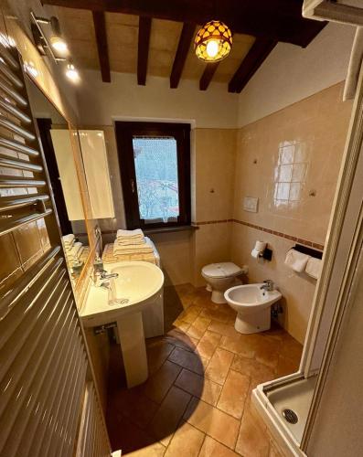 a bathroom with a sink and a toilet at Il Casaletto Visso - Appartamenti in Visso