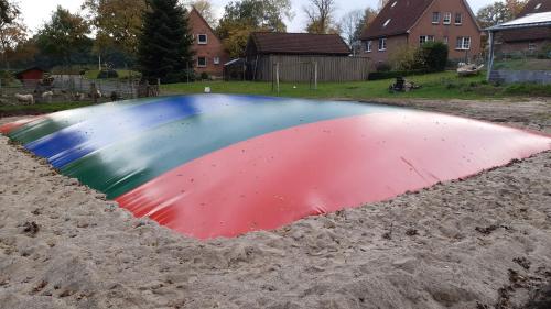 a large colorful object in the sand at Ferienhof Lucht in Mühbrook