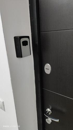 a black door with a toilet paper dispenser on it at Apartment Twins Sabac in Šabac