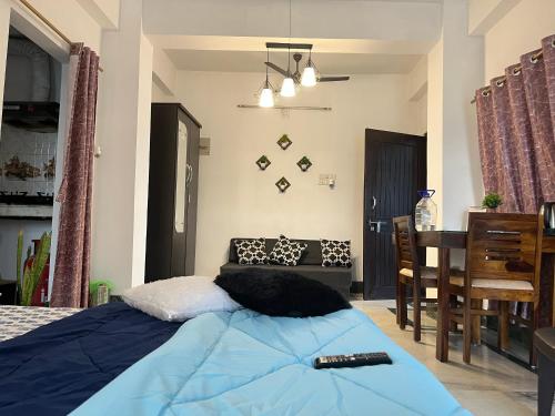 a bedroom with a bed and a dining room at Beltola serenity homestay in Guwahati
