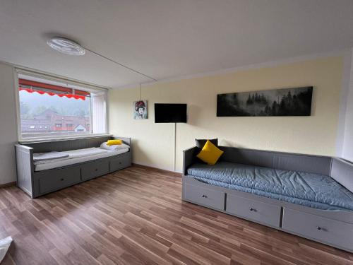 a bedroom with a bed and a large window at Domview Apartment in St. Blasien