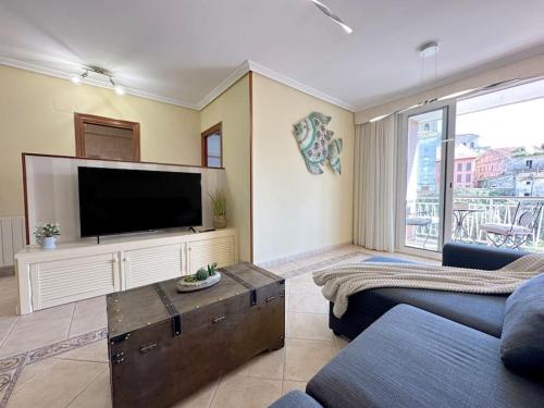a living room with a large flat screen tv at Apartamento en centro de Laredo in Laredo