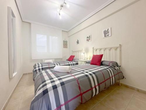 two twin beds in a room with at Apartamento en centro de Laredo in Laredo