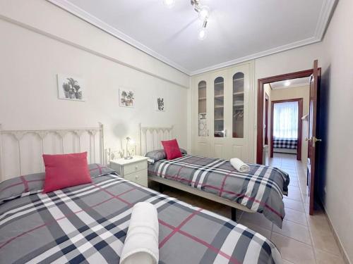 a bedroom with two beds in a room at Apartamento en centro de Laredo in Laredo