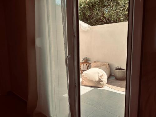 an open door to a patio with a pillow at Tzane Luxury Suites - Luxury Suites in the City Center for Comfort & Privacy By Villa Mana Gers in Zakynthos Town
