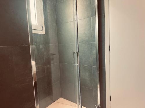a shower with a glass door in a bathroom at Tzane Luxury Suites - Luxury Suites in the City Center for Comfort & Privacy By Villa Mana Gers in Zakynthos Town