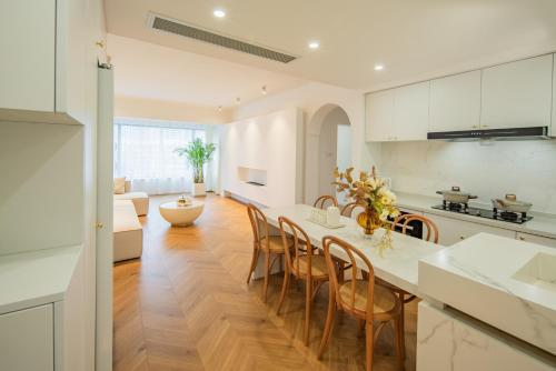 a kitchen and living room with a table and chairs at Tonight Homestay South Shanxi Road Shanghai in Shanghai
