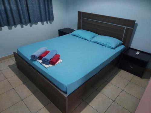 a bedroom with a bed with two towels on it at Magic Sea Apartments in Larnaka
