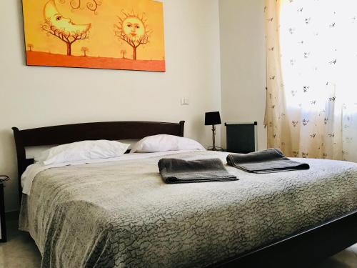 a bed with two towels on it in a bedroom at Borgonovo Penthouse 13P in Pizzo