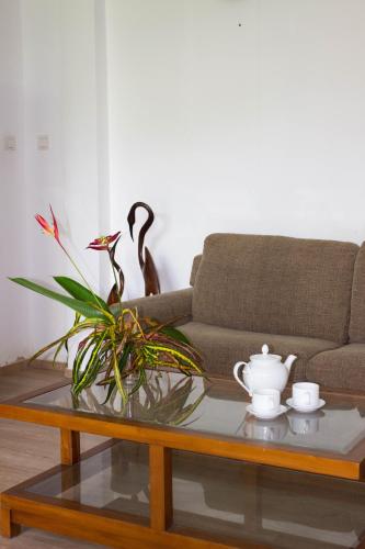 a living room with a couch and a coffee table at URALSURF HOUSE in Weligama