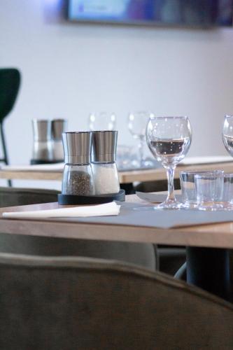 a table with wine glasses on top of it at Campanile Villeneuve-Sur-Lot in Pujols Lot et Garonne