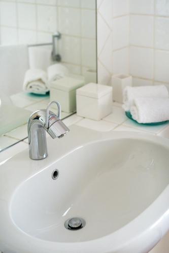 a white sink in a bathroom with a mirror at Private Jacuzzi - Villa Bellosguardo in Florence Historic Center in Florence