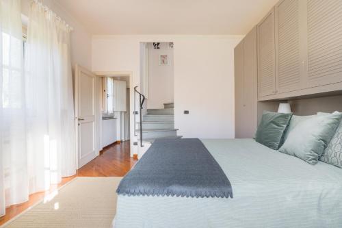 a bedroom with a large white bed with blue pillows at Private Jacuzzi - Villa Bellosguardo in Florence Historic Center in Florence