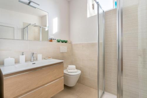 a bathroom with a toilet and a sink and a shower at Private Jacuzzi - Villa Bellosguardo in Florence Historic Center in Florence