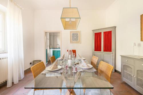 a dining room with a glass table and chairs at Private Jacuzzi - Villa Bellosguardo in Florence Historic Center in Florence