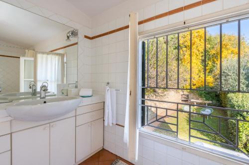 a bathroom with a sink and a large window at Private Jacuzzi - Villa Bellosguardo in Florence Historic Center in Florence