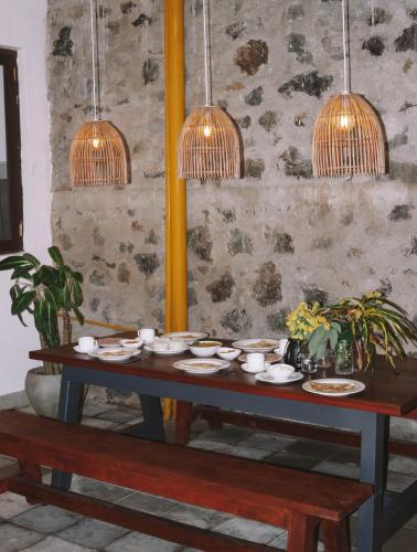 a table with dishes on it with pendant lights at URALSURF HOUSE in Weligama