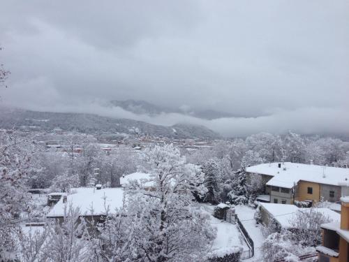 a city covered in snow with a mountain in the background at Le Mimose Holiday House di Como - Grandate in Grandate